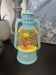 snow globe with pink flamingo in turquoise blue lantern