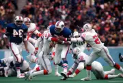 Running back OJ Simpson Buffalo Bills gets tackled by Jack Mildre- 1974 Photo