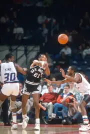Alvin Robertson San Antonio Spurs passes the ball over the Basketball 1988 Photo