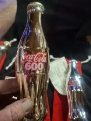 Gold Coke Bottle And A Silver Coke Bottle With Certs And A Gold One Wout Cert