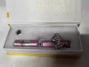 Renegade Laser Green Key Chain USB Charging Laser Pointer In A Pink Housing.