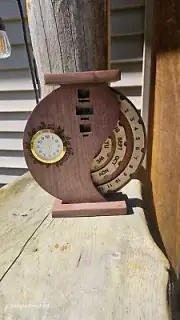 Walnut calendar with clock inlayed