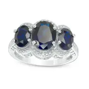 Oval Lab-Created Blue Sapphire and Diamond Accent Three Stone Frame Ring in Sterling Silver