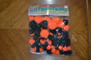 Unopened package of Darice Halloween pom poms - 100 pieces of various sizes.