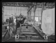 Engine being hoisted into Wizard Smith's car in a warehouse, NSW, - Old Photo