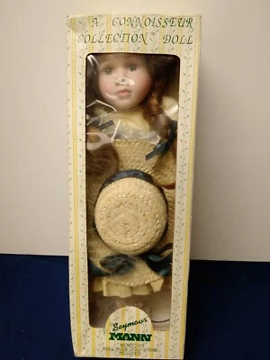 A Connoisseur Collection Seymour Mann Doll with Straw Hat, Brown Hair & Stand