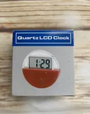 Quartz LCD Clock Small, circular quartz LCD clock and calendar Red and Clear