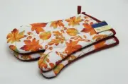 New with tags Home Collection multi color fall pattern oven mittens set of two.