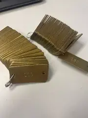 50 BRASS NUMBERED TAGS 100 - 150 aprox 2" long x 1" high