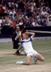 American tennis player John McEnroe crouches to his knees in cele - Old Photo