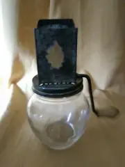 Vintage clear glass jar with metal grinder and wooden handle
