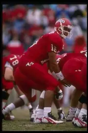 Quarterback Jim Arellanes Fresno State Bulldogs stands behind cent- Old Photo