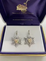 Black Hills Gold sterling silver and gold snowflake earrings by Landstroms, read