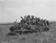 Canadian Army personnel riding a Centurion tank partially camoufl- 1961 Photo