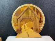 Hand crafted solid wood intarsia wall hanging featuring covered bridge