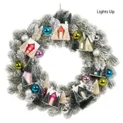 Snow Covered Branches With Ball Ornaments And Led Lit Houses Wreath