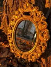 Mirror made of gypsum in a vintage style, oval wall, gold-colored baroque