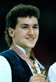 Elvis Stojko of Canada with his gold medal after winning the men's- Old Photo