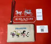 NWT Coach X Peanuts Corner Zip Wristlet Leather Snoopy and Friends Motif Ivory