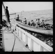 Gloucester,Massachusetts. A dory being pulled alongside the mother ship