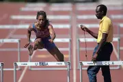 American track coach Bobby Kersee times runner Gail Devers as she - Old Photo
