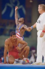 Cecilio Rodr�guez of Cuba kneels on the floor as Rodney Smith USA - Old Photo