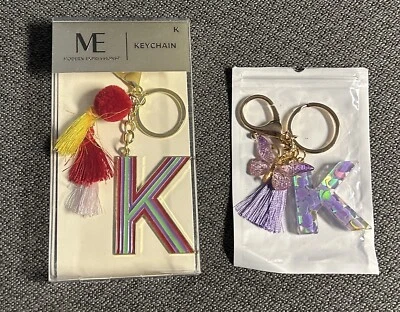 TWO “K” INITIAL TASSEL KEYCHAINS - ME MODERN EXPRESSIONS & PURPLE UNBRANDED