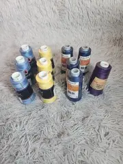 Serger thread, lot of 10 spools, blue, yellow, purple.