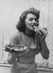 Italian actress Sophia Loren eating flatbread, 1954 Old Photo