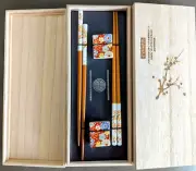 2 SETS OF HANDPAINTED WOOD CHOPSTICKS, PORCELAIN REST HOLDERS, PALOWNIA WOOD BOX