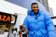 Mike Tyson holds a pigeon while walking on the Atlantic City board- Old Photo 1