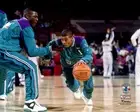 Muggsy Bogues Hornets Unsigned Warming Up w/Larry Johnson Photo