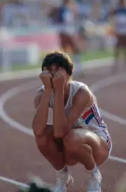 English track athlete Kathy Smallwood-Cook crouches down on the t - Old Photo