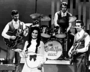 Loretta Lynn 1960's in concert 8x10 inch photo with her Loretta Lynn band poster