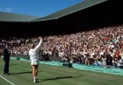 Steffi Graf of Germany waves to the crowd with her trophy after de- Old Photo