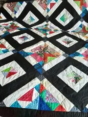 Handmade black and white diamond quilt which measures approximately 83 by 72 inc