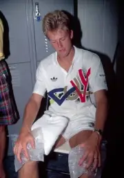 Stefan Edberg of Sweden nurses his knees with ice packs after defe- Old Photo