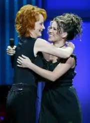 Singer Reba McEntire and American Idol winner Kelly Clarkson embra - Old Photo