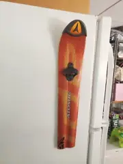 Atomic ski bottle opener. Magnets stick to fridge
