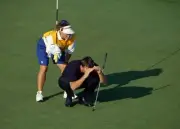 Nick Faldo of England crouching down on a green with his caddie Fa- Old Photo