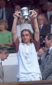 Olivier Mutis of France lifts the trophy after defeating Nicolas K- Old Photo