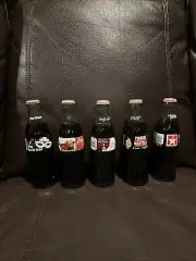 Collectible Coca Cola Bottles (5) - New- Mardi Gras, Santa, Holyfield, Dayton