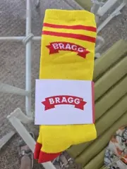New In Package BRAGG acrylic Socks Yellow And Red Logo