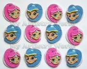 A set of twelve edible Shimmer and Shine themed cupcake toppers.
