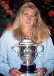 Steffi Graf of German poses with the trophy after defeating Arantx- Old Photo