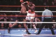 Mike Tyson in action landing left hook vs Larry Holmes at Conventi- Old Photo