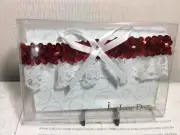 WEDDING OR PROM GARTERS New in plastic casing RED SEQUIN with White Bow
