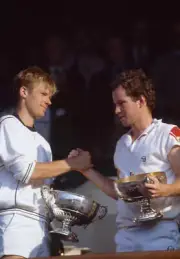 Peter Fleming and John McEnroe of the USA shake hands whilst hold - Old Photo
