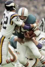 Running back Larry Csonka Miami Dolphins is hit by defensive back- 1974 Photo 1