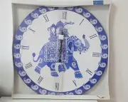 blue and white clock with elephant mural and beautiful detailing